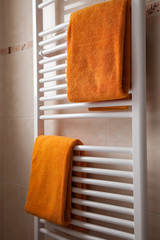 orange towels on heater