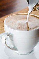 art latte on a cappuccino coffee cup