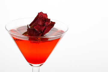 rose floating in a red liquor