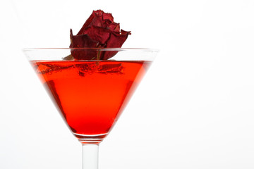 rose floating in a red liquor