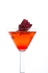 rose floating in a red liquor
