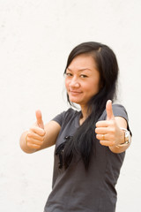 young woman giving two thumbs up