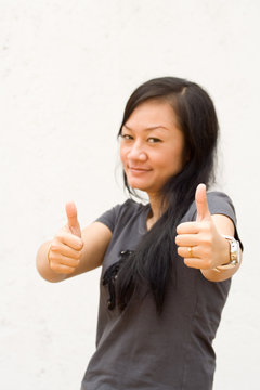 young woman giving two thumbs up