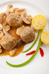 Roasted meatballs with mushrooms and boiled potatoes