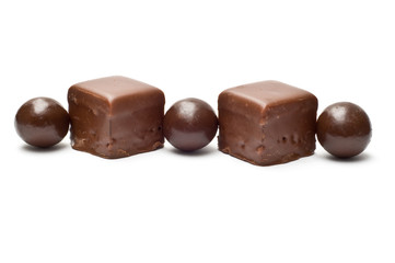 Lined chocolate balls and cubes side view