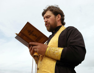 Orthodox priest reads prayer
