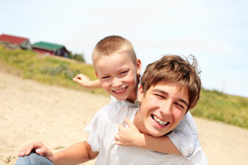 Fototapeta premium happy teenager and kid on the beach