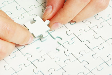 hands holding puzzle