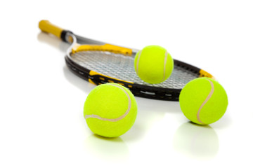 Tennis racket and balls on white