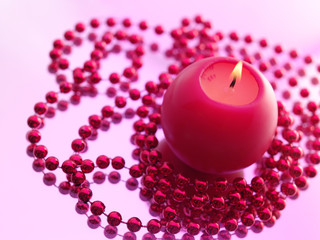 Holiday still life with candles on pink background