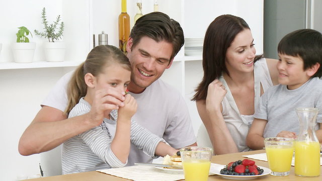 Family at home in Kitchen having breakfast