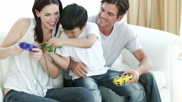 Parents and son playing video Games at home