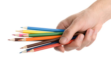 Naklejka premium Hands with colored pencils over white
