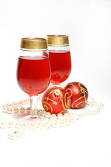 Christmas still life - glasses with wine,red balls and string of