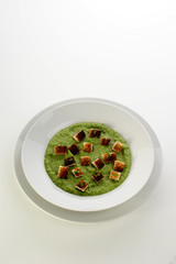organic home made pea puree on a white plate