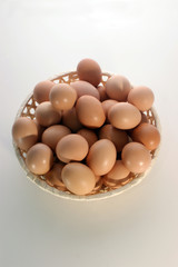 some fresh brown organic eggs in a basket