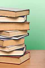 Pile of books  on desk