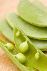 fresh peas on wooden background