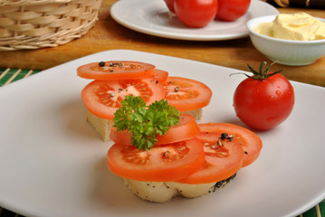 half bread roll with organic tomato slices