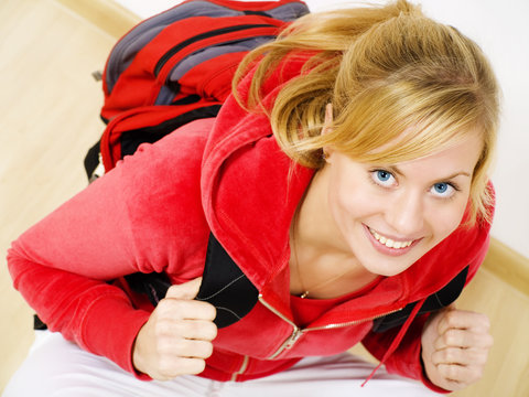 Smiling Blond Teenager Sitting With Backpack