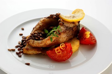 grilled carp fillet with organic vegetable on a plate