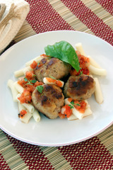 rissole with grilled organic tomato on a plate