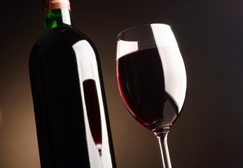 Glass and bottle of red wine.