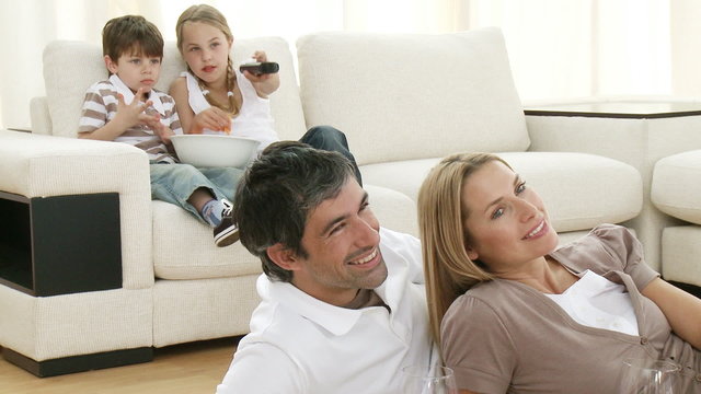 Family in living-room watching television