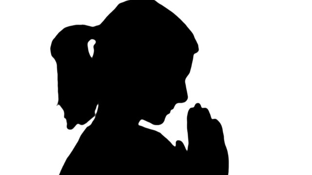 Woman prays in silhouette - HD