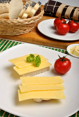 half bread roll with cheese on a plate