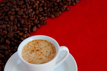 cup with coffee and grain expressed on red background