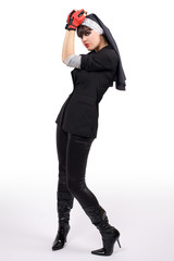 Beautiful young nun is in the red gloves