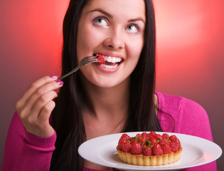 Young beautiful woman with raspberry cake