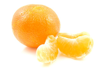 whole mandarin and parts over white background