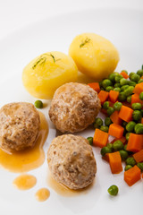 Roasted meatballs with boiled potatoes, peas and carrot