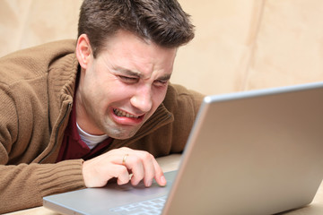 Mann traurig vor Laptop