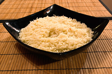 boiled rice in a deep black plate