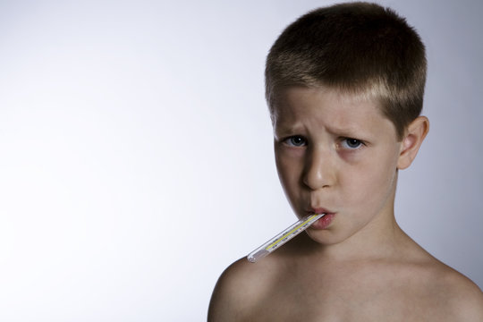 Unhappy Sick Child With Thermometer