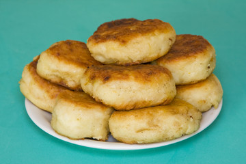 Potato cakes with meat on a green background
