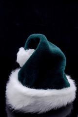 Green christmas hat on black