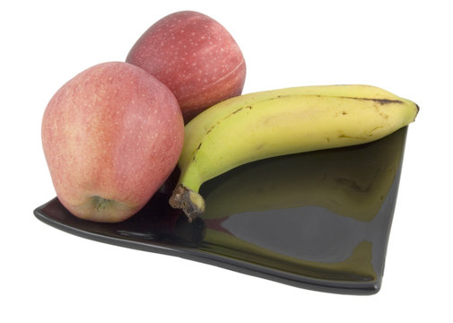 two apples and banana on plate isolated on white