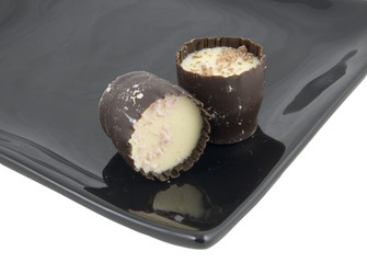 expensive chocolates on serving tray isolated on white