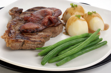 grilled rump steak and bacon with organic vegetable