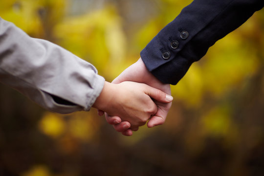Romance - Couple holding hands in fall
