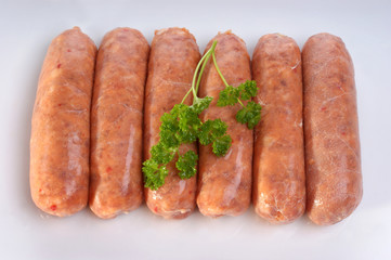 pork black pepper sausages on a white plate