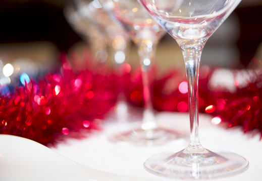 Wineglasses and red decorations in background