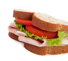 A ham sandwich on wheat on a white background