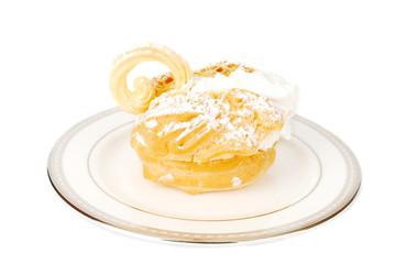 Eclair swan dessert on he plate.