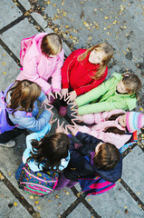 friendship and teamwork concept with young schoolgirls group