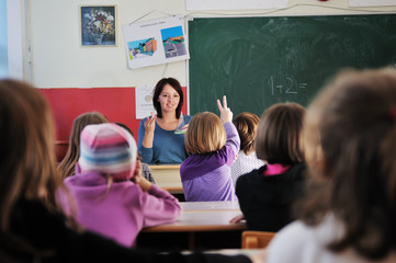 happy teacher in  school classroom